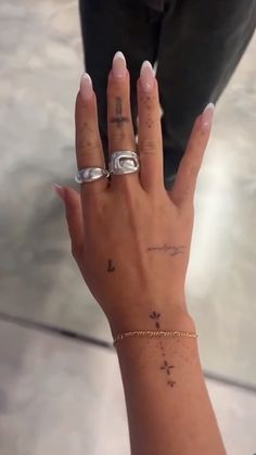 a woman's hand with two rings on it