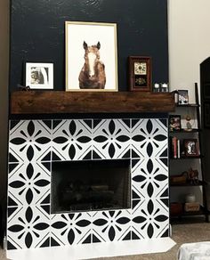 the fireplace is decorated with black and white tiles