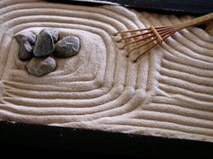 a bamboo stick and some rocks on top of a mat in the shape of a circle