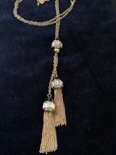 "This tassel necklace is a gold-tone chain holding two rhinestone and chain tassels from a central rhinestone fob. 30\" long plus 3\" extender and 6\" dangle. Stunning and unique. Dangles in the shape of cylinders. Tassels are 2\" long. Lobster clasp" Gold Tassel Necklace For Party, Ornate Long Gold Necklace, Elegant Long Gold Tassel Necklace, Gold Long Tassel Necklace, Victorian Gold Rectangular Necklace, Gold Beaded Tassel Long Necklace, Length Necklace, Black Enamel, Tassel Necklace