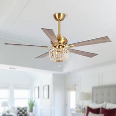 a bedroom with a bed, ceiling fan and chandelier