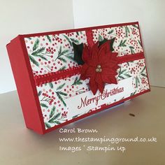 a red and white christmas card with poinsettis on it's side