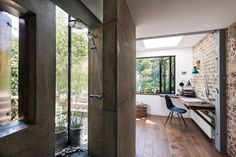 a bathroom with a shower, desk and chair in it's center wall is shown