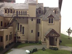 a doll house is shown on display in front of a building with windows and balconies