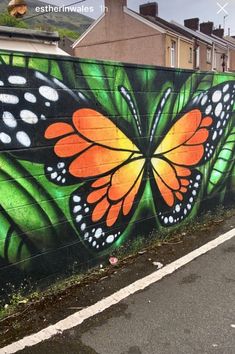 a large butterfly painted on the side of a building