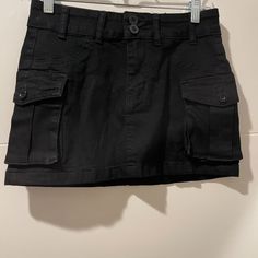 Cute Cargo Skirt. Black. Never Worn (Though Missing Tags). Sits Lower On The Hips (Low To Mid Rise Depending On Torso Length). Fitted Black Cargo Skirt With Pockets, High Waist Black Cotton Mini Skirt, Casual Black Cargo Skirt For Summer, Black Lined Cargo Skirt, High Waist Black Cargo Skirt, Casual Black Cargo Skirt For Spring, Black High Waist Cotton Cargo Skirt, High Waist Black Cotton Skort, Black Cotton Mini Cargo Skirt