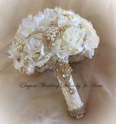 a bridal bouquet with white flowers and pearls