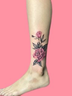 a woman's foot with a rose tattoo on her left leg and pink background