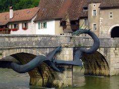 an artistic sculpture on the side of a bridge