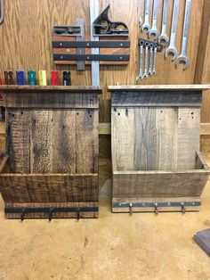 two wooden boxes with tools on top of them