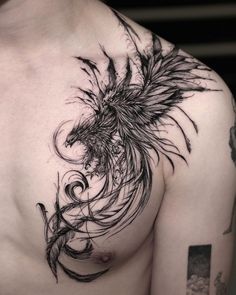 a man's chest with an intricate tattoo design on his left arm and shoulder