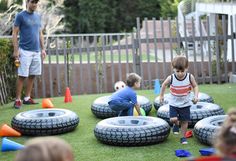 a group of kids playing with inflatable tires