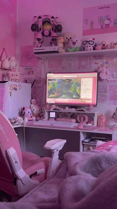 a bedroom with pink walls and lots of stuffed animals on the wall, including a computer