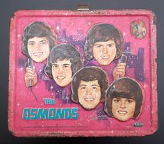 an old lunch box with the faces of the beatles on it and stars in the background