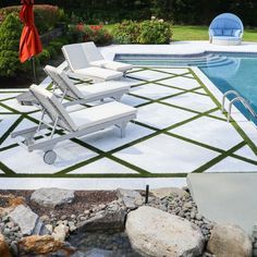 a pool with chairs and an umbrella next to it