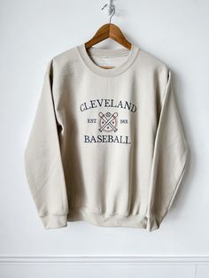 Cheer on your favorite team with this custom embroidered Baseball Crewneck! Wear this sweatshirt everywhere. Cheer on your MLB team from the bleachers or at home in a fleece sweatshirt! Order from sizes S-3XL. These are unisex sweatshirts, and they fit true to size! Look at your high school/ college/ sports tees and sweatshirts for sizing reference! This crewneck can be customized with 1-2 thread colors. Looking for a color sweatshirt or thread color not listed? Message me and I will see if I ca Cheap Varsity Sweatshirt With Embroidered Logo, High School Merch Ideas, Sporty Embroidered Crew Sweatshirt, Collegiate Crew Neck Sweatshirt With Embroidered Graphics, Sporty College Sweatshirt With Team Logo, Baseball Season Fan Apparel Sweatshirt, College Crew Sweatshirt With Embroidered Logo, Varsity Sweatshirt With Embroidered Logo For Sports Season, College Crew Neck Sweats With Embroidered Logo