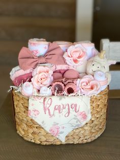 a basket filled with pink flowers and stuffed animals