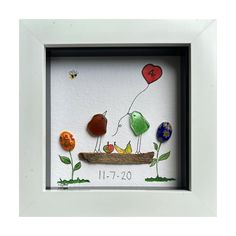 a framed artwork with birds and balloons in it