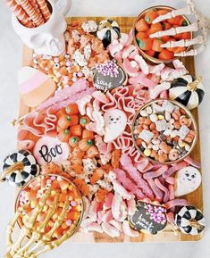 a wooden tray topped with lots of different types of candy and candies on top of it