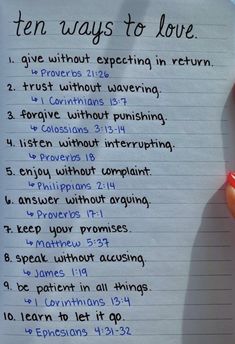 a hand holding a piece of paper with writing on it that says ten ways to love