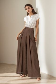 You can Pair them with a fitted top for a balanced look. Elevate your wardrobe - experience the blend of luxury and comfort with our linen wide-leg pants. DETAILS: * 100% linen, the wide-leg pants is made from high-quality linen, providing a breezy and comfortable feel. * Two side pockets * Zipper and button front closure * Pleated detail * High waisted pants * Wide leg pants * Perfect for spring, summer * Dry clean MODEL SIZE Bust 85 cm(33.4") Waist 67 cm(26.7") Height 168cm (5' 6") She wears s