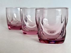 three glasses sitting next to each other on a table