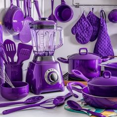 purple kitchenware and utensils are displayed on the counter