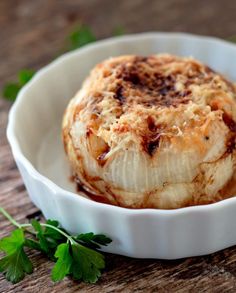 baked viadala onion in a white dish with parsley on the side and text overlay