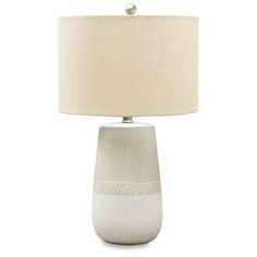 a white table lamp with a beige shade