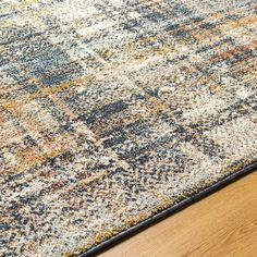 an area rug is shown with wood flooring and blue, yellow, orange and white colors