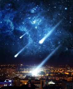 two comets are seen in the night sky above a cityscape with buildings and lights