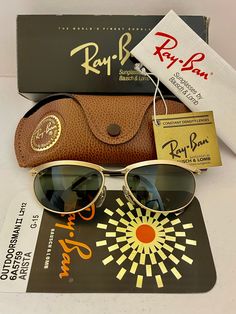 "PLEASE READ ALL THE DESCRIPTION AND CHECK ALL PHOTOS BEFORE BUYING . you are buying a new old stock vintage OVAL RAY BAN WITH DECO METAL LOOKS  , MADE IN USA   G15 GREEN made original ,  SPORT SUNGLASSES  they are new ,,in mint condition  ,, size   LENSES ARE G15 GREEN MINT CONDITION  ,, BAUSCH & LOMB  RAY BAN : they are original ,,bausch and lomb  made in usa   LARGE size 50mm  RAY BAN LOGO ON THE RIGHT LENS ,, BOTH LENSES ETCHED BL ON THEM     FRAME IS METAL ( DECO METAL , GOLD OR COPPER LOOK Designer Tinted Sunglasses For Outdoor, Designer Polarized Sunglasses For Outdoor, Designer Polarized Sunglasses For Outdoors, Ray Ban Logo, Sport Sunglasses, Green Mint, Sports Sunglasses, Eyewear Sunglasses, Ray Ban