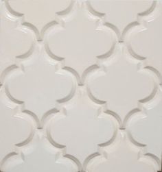 a white tile with an intricate design on it