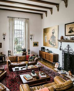 a living room filled with furniture and a fire place in front of a large window