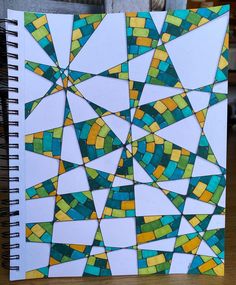 a spiral notebook covered in stained glass tiles