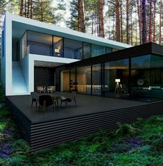 a modern house in the woods surrounded by trees