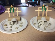 two paper plates with crosses and rocks on them