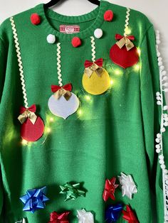 a green sweater with christmas decorations on it