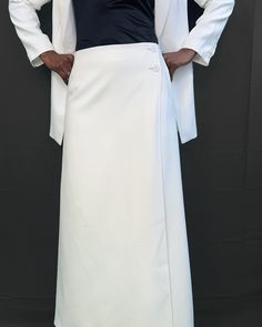 A maxi skirt meticulously crafted with polyester, ensuring both durability and a sophisticated drape. The addition of a viscose inner lining promises supreme comfort while enhancing the skirt's graceful flow. Our skirt wraps on the side with the help of two buttons. Additionally, it features a usable pocket on each side for convenience. Elegant Spring Wrap Skirt, White Formal Full-length Maxi Skirt, White Maxi Skirt For Formal Occasions, White Formal Maxi Skirt, Formal Full-length White Skirt, Formal White Maxi Skirt, Formal Full Length White Skirt, Elegant Fitted Wide Leg Maxi Skirt, Asymmetrical Pleated Maxi Skirt For Formal Events