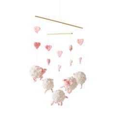 a crocheted sheep mobile with hearts hanging from it's sides on a white background