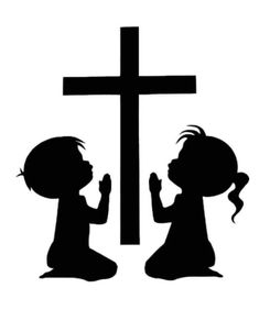 two children kneeling in front of a cross