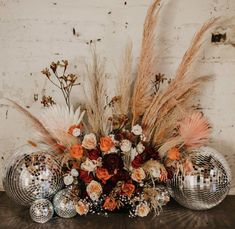 a table topped with disco balls and flowers