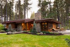 a house in the woods with grass and trees