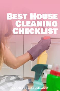 a woman is cleaning the kitchen with her gloves on and she is holding a rag