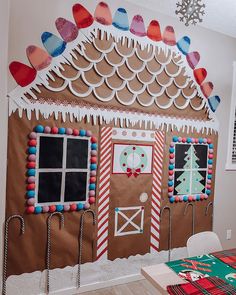 a gingerbread house decorated with candy canes and icing