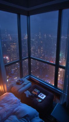 a bedroom with a view of the city at night