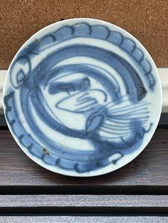 a blue and white bowl sitting on top of a counter