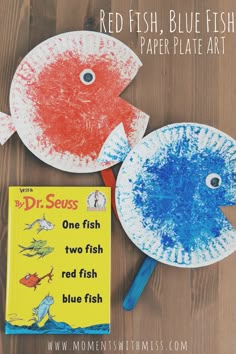 two paper plates with fish on them, one is blue and the other is red