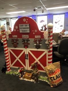 an office cubicle decorated for christmas with decorations on the front and side walls, along with santa's sleigh