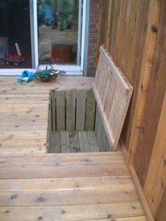 a wooden bench sitting on top of a wooden floor next to a door and window